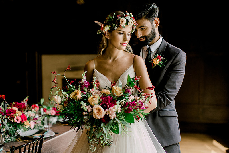 Photo of couple embracing in the Oak Room.