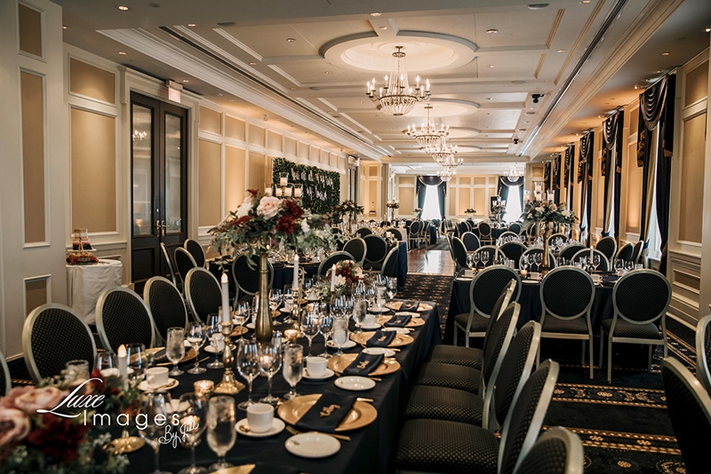 Decorated Grand Ballroom wedding reception (navy, burgundy, gold). Photo by Luxe Images by Jill).